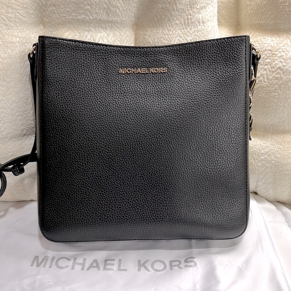 Michael Kors pebbled leather black messenger bag.